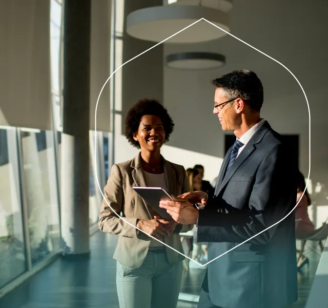 Two colleagues discussing workplace benefits in a bright modern office.