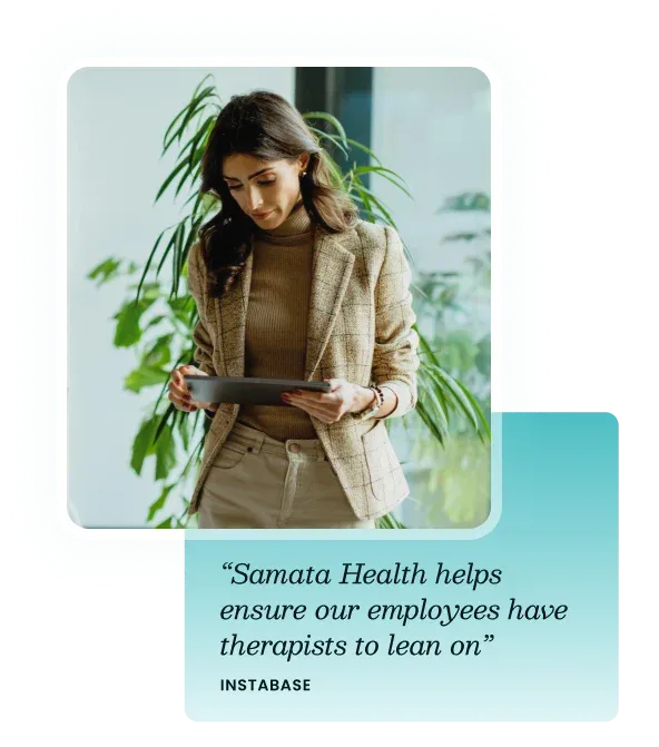 A professional woman reviewing information on a tablet in a bright office.